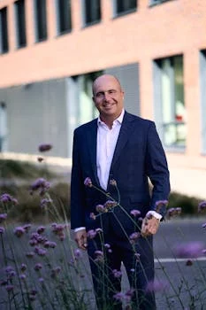 friendly sommelier holding wine bottle in restaurant